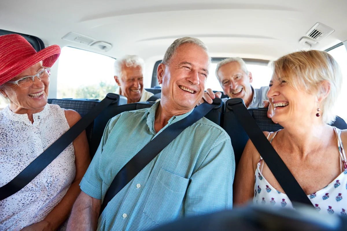 Group of senior friends in a van on a field trip